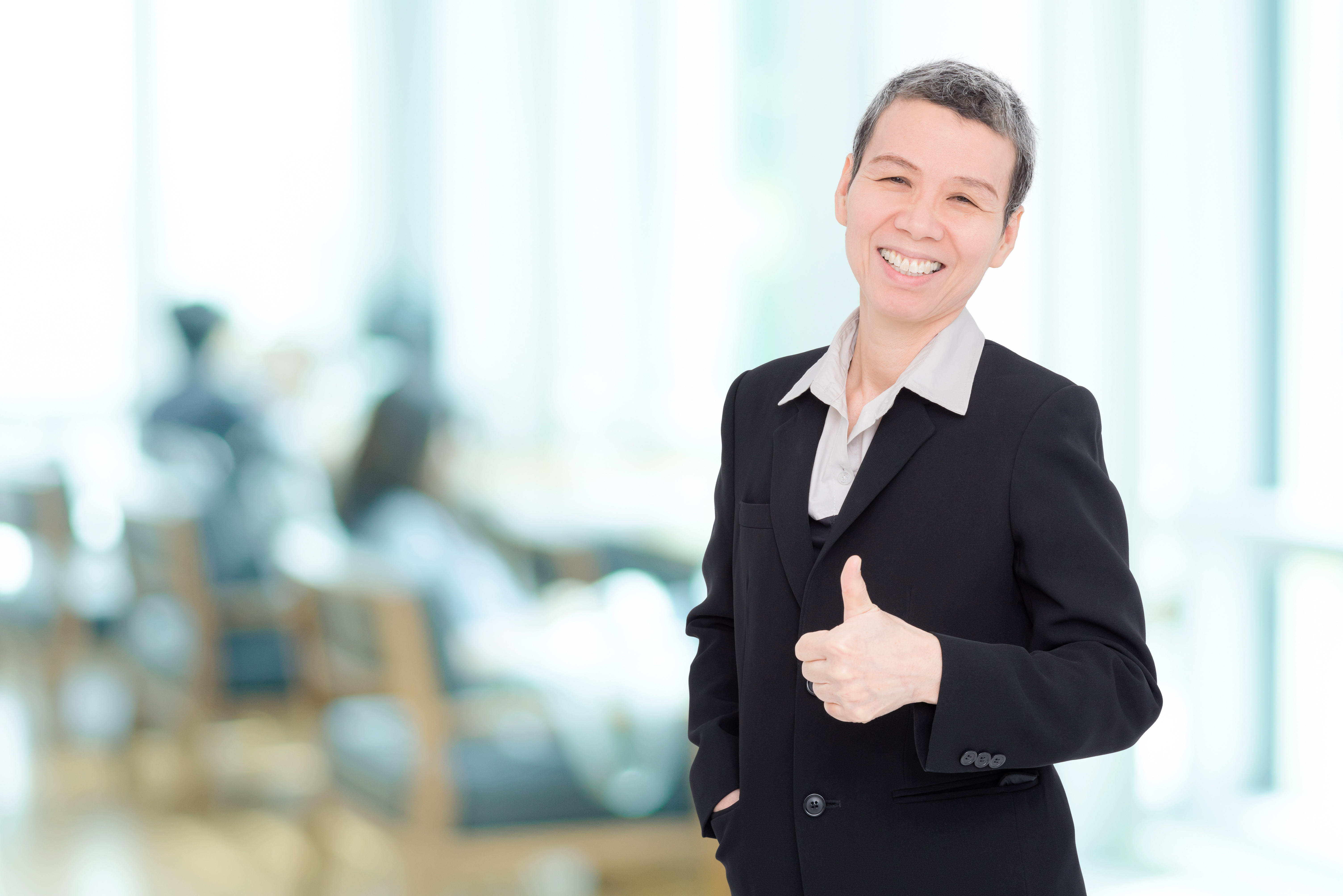 Senior businesswoman showing thumb up